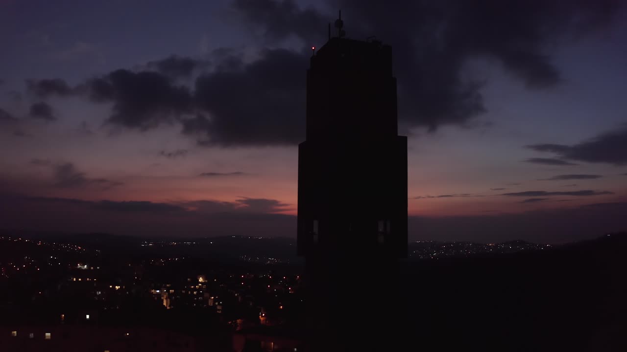 Silhouette Tower at Sunset over City