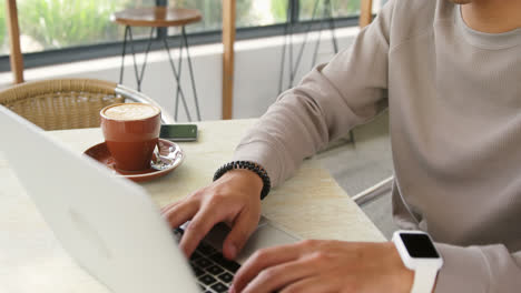 man checking time while using laptop 4k