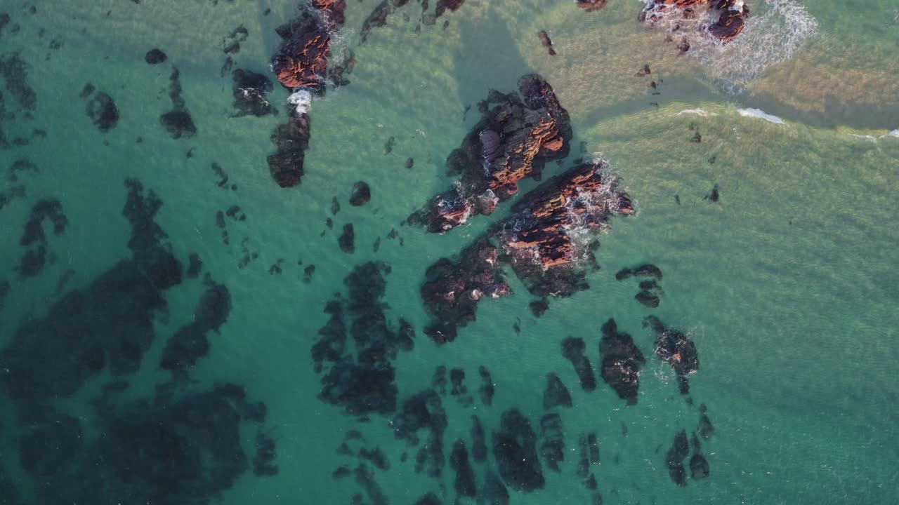 Turquoise Sea With Calm Waves Over The Rugged Shore In Portugal