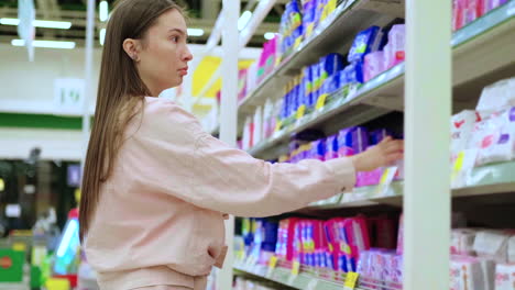 woman shopping for sanitary products in a supermarket