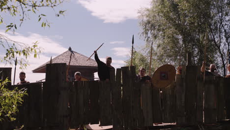 medieval reenactment: soldiers behind a wooden wall