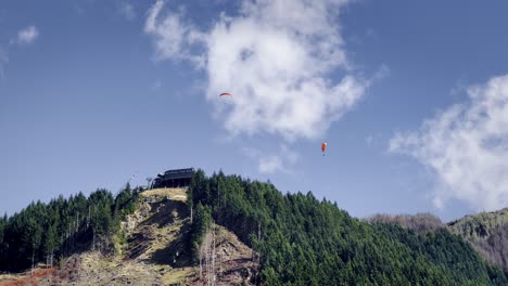 paragliders over the iconic queenstown skyline and ben lomond reserve