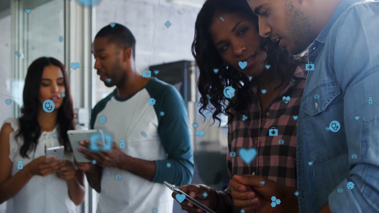 Animation of network of medical icons against diverse man and woman discussing at office