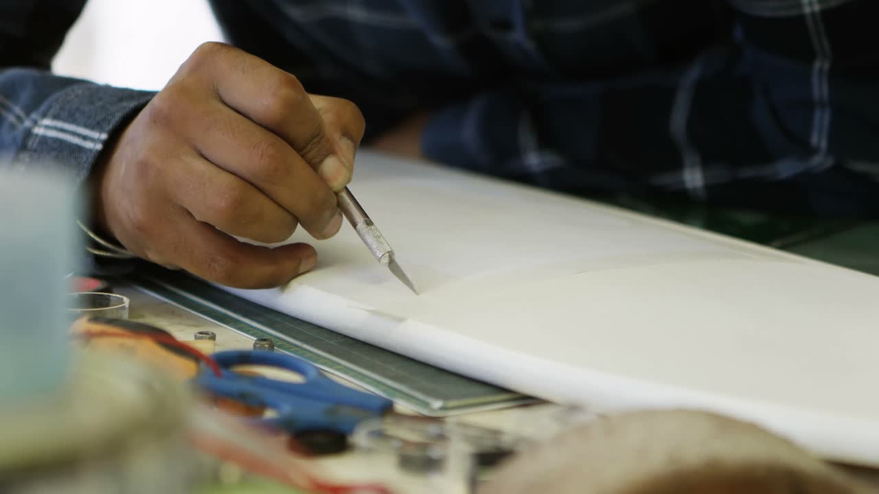 Man making a design on skateboard 4k