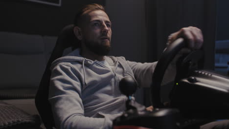 man playing racing video game at home
