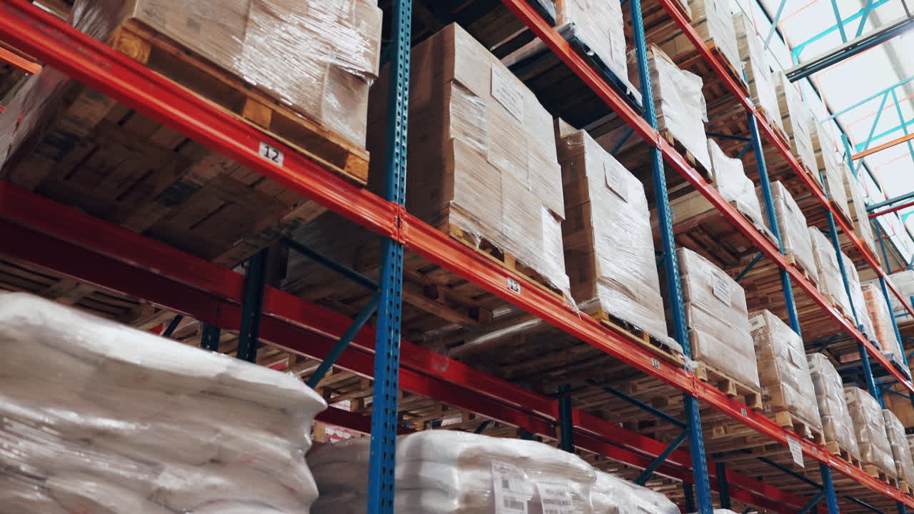 Warehouse shelves with stacked boxes on pallets