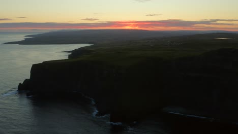 aerial tracking shot capturing the beauty of a sunrise over the majestic northern cliffs of moher