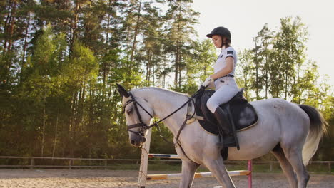 it's a perfect horse walk. horsewomen is riding on her horse before training.