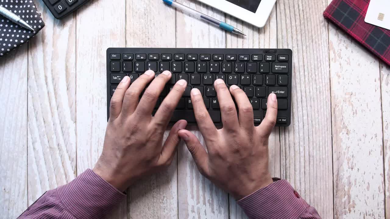 Person typing on a keyboard at a desk