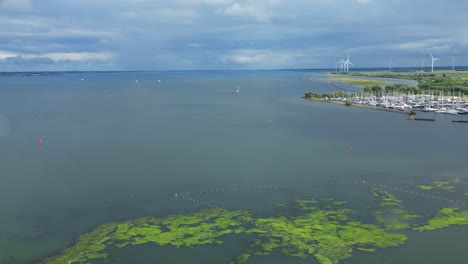 Schöne-Luftdrohne-über-Stellendam,-Hafen,-Boote-Sind-Angedockt,-Sumpf,-Sumpf-Und-Mündung-Mit-Windmühlen-In-Der-Landschaft