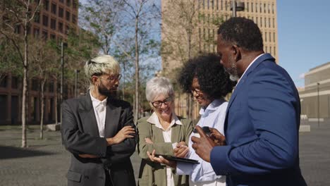 Business team using tablet outdoors