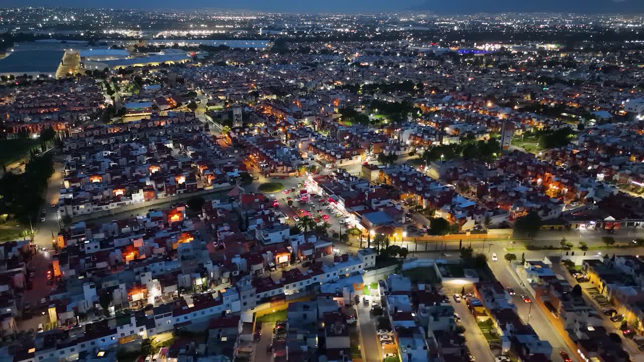Nighttime orbital drone shot of a residential subdivision with similar houses in the municipality of Cuautitlán Izcalli, part of the Mexico City metropolitan area