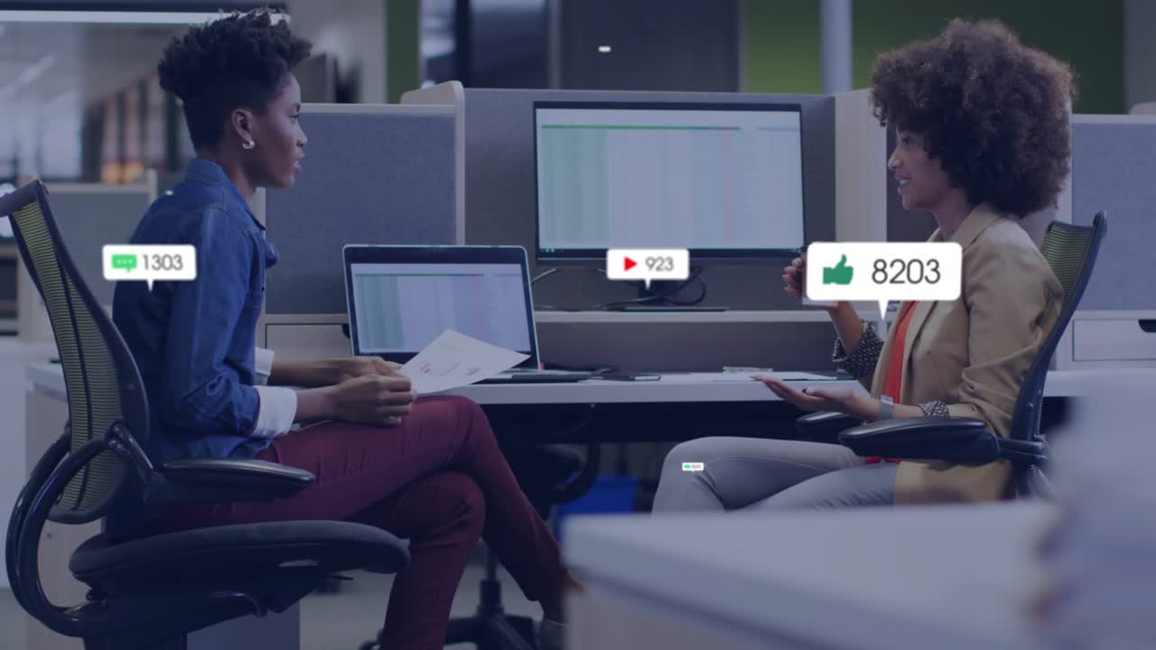 Colleagues reviewing reports while green bubble popping revealing marketing metrics around monitor