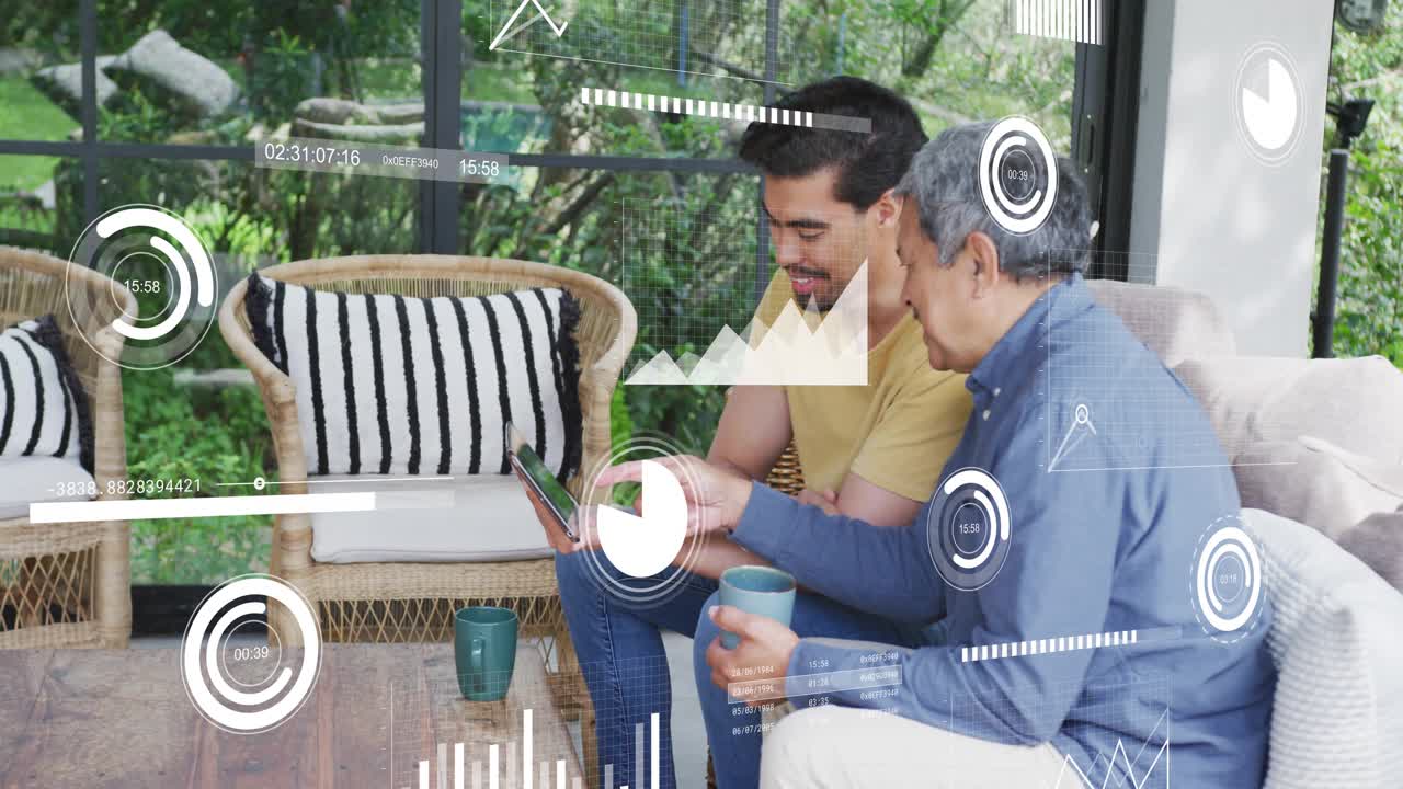 Adult man tilting tablet and activating data charts while senior man tapping and checking finances