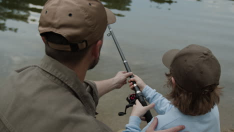 father and child fishing at the lake