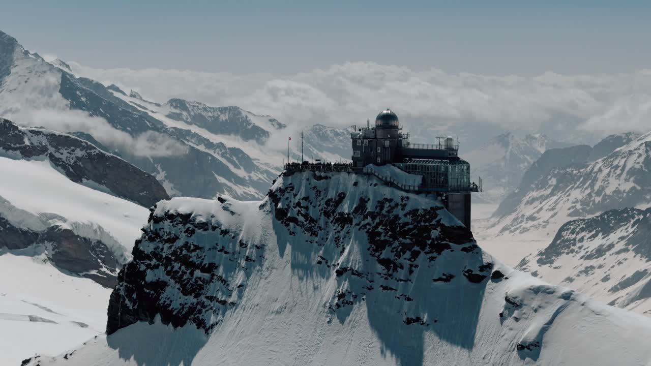 Flyover of Jungfraujoch Station with Snowy Alps and Glaciers