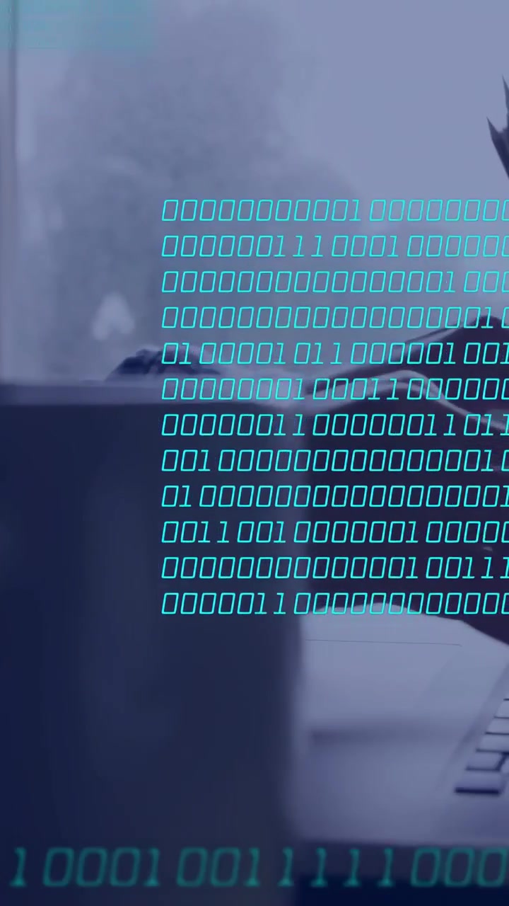 Vertical video: Woman placing hands on laptop, starting cyan binary panels overlaying desk for tech
