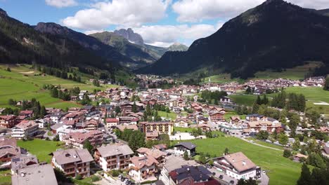 vigo di fassa at fassa valley , trentino, dolomites, italy - aerial drone view of the picturesque mountain village