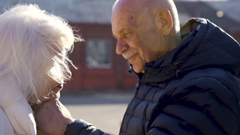 senior couple holding hands in the street on a winter day