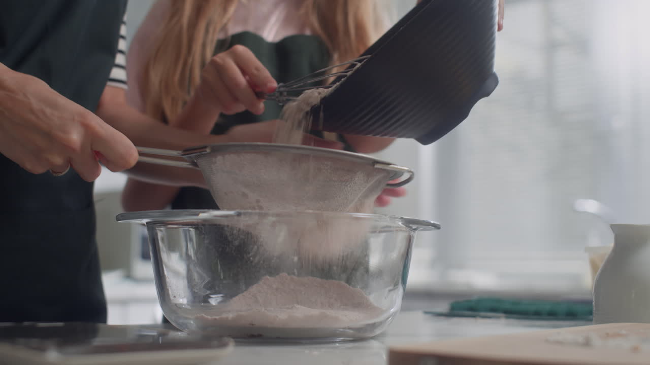 Mother and Daughter Sifting Flour for Cookie Dough