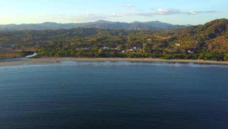 Aerial-towards-Samara-Beach-and-town-in-the-Guanacaste-Province,-Costa-Rica