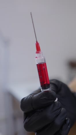syringe with red liquid