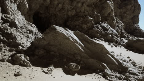 a cave opening in a rocky desert cliff