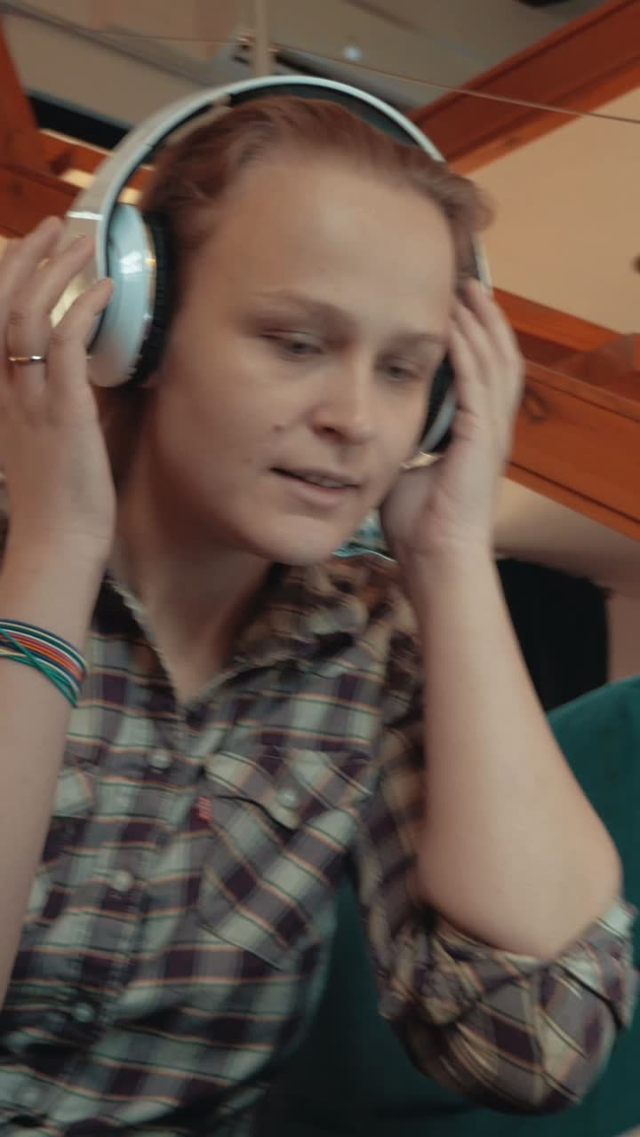 Woman with headphones holding a cup