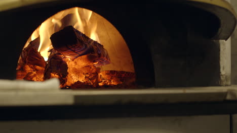 closeup of a wood burning fire in a neapolitan style pizza oven in a nice restaurant