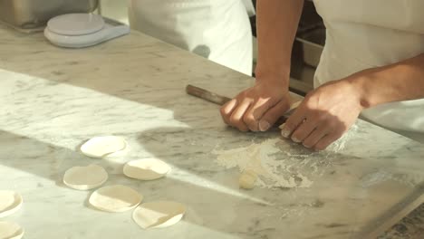 Sculpt-the-dough-on-the-table-cook-dumplings-with-meat-making-meat-dumplings-high-quality-fullhd-footage