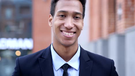 portrait of smiling african businessman looking at camera