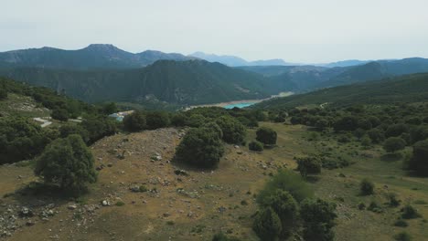 an alpine lake comes into view as a drone flies over an estate in southern spain