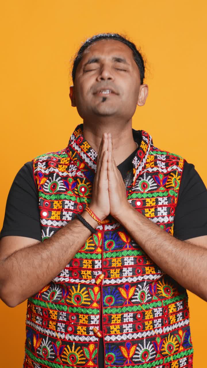 Indian Man Praying with Namaste Gesture and Traditional Vest