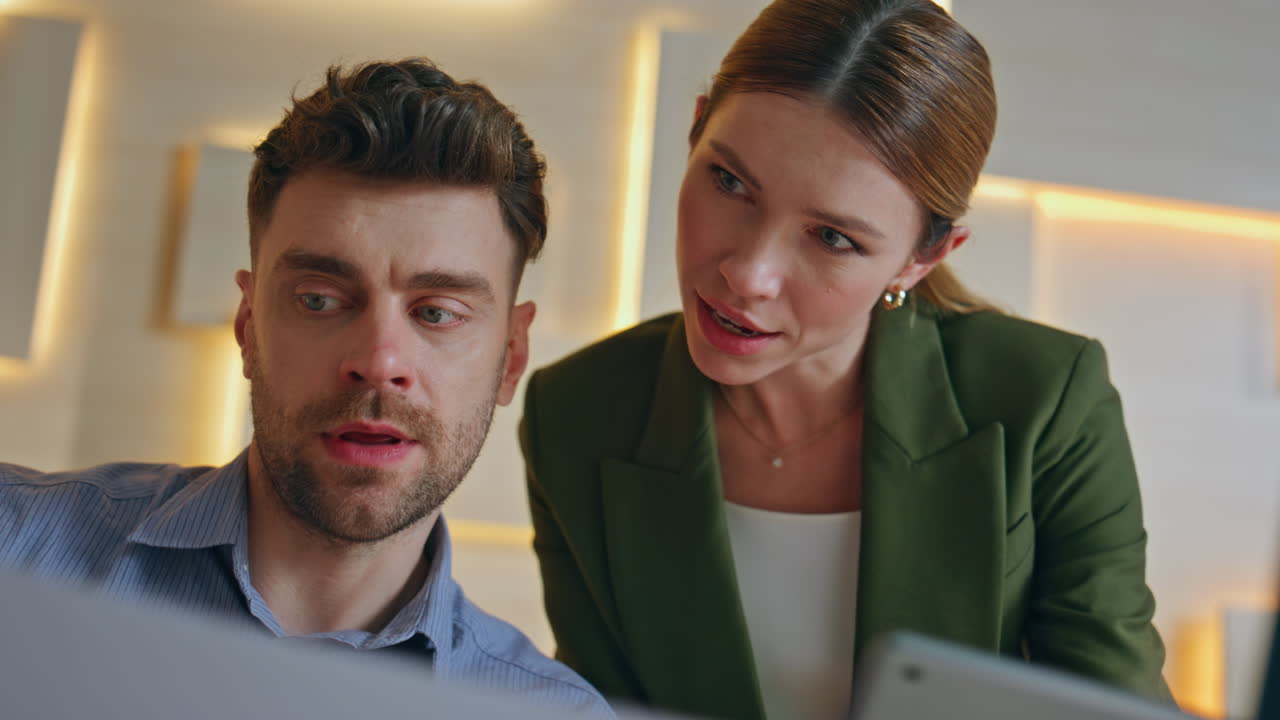 Two manager collaborating workplace looking documents closeup. Smiling colleague