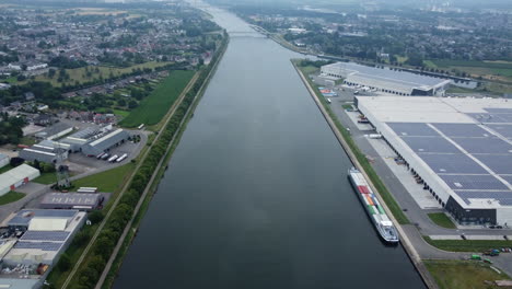 aerial view of a canal with cargo ship and industrial area