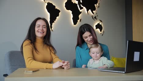 a travel agency helps a young mother choose a holiday tour