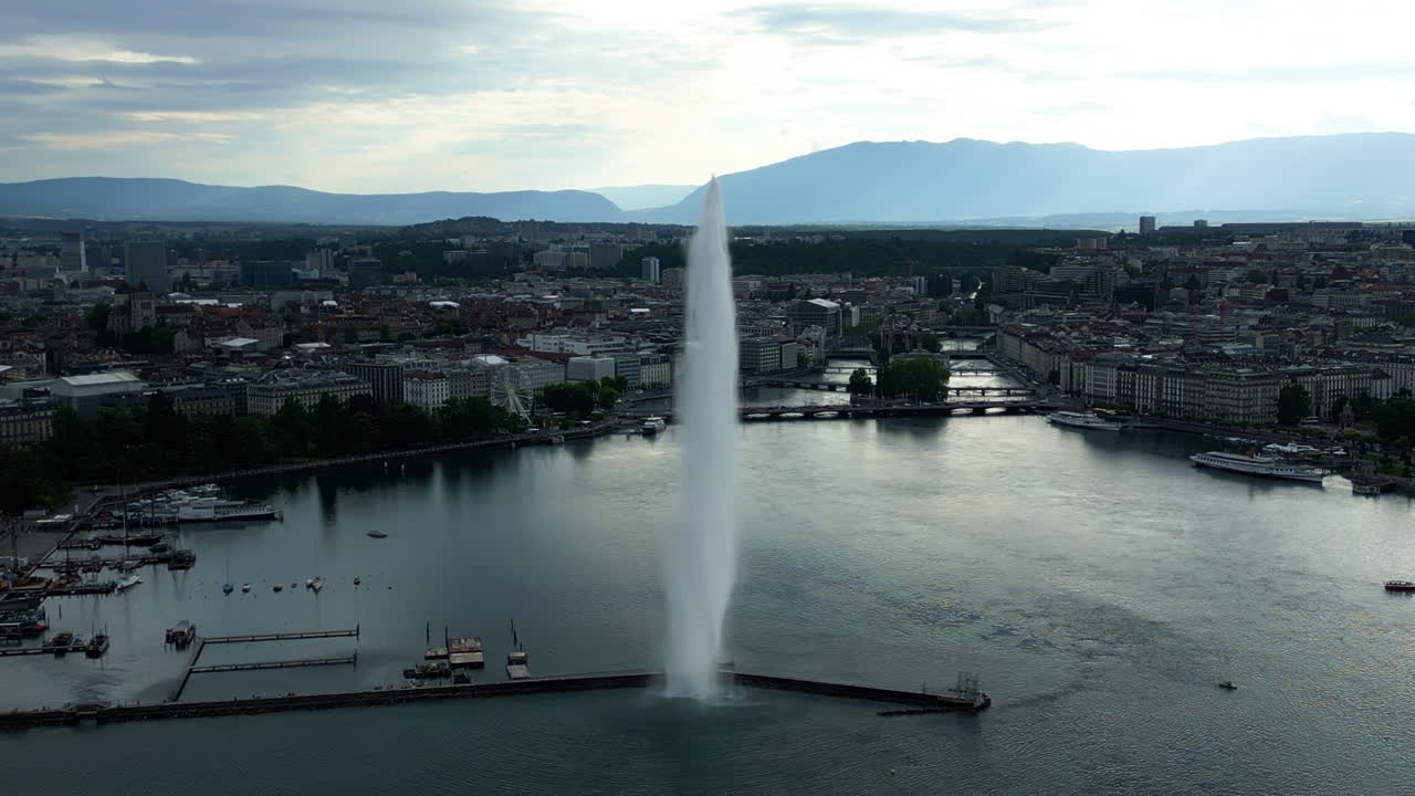 Establishing drone shot close to water fountain of Geneva during the day (Rade of Geneva) in canton of Geneva, Switzerland