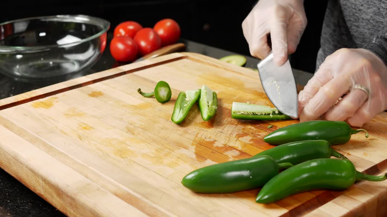 Slicing jalapeno chili peppers and removing seeds
