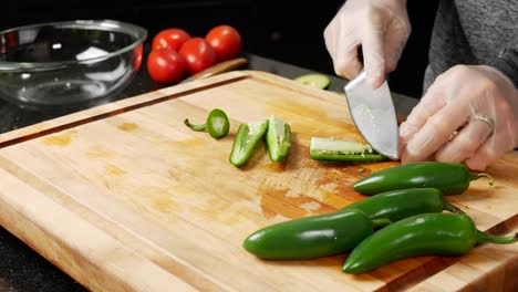 slicing jalapeno chili peppers and removing seeds
