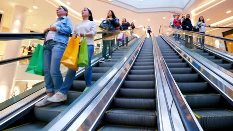 people on escalators in a shopping mall