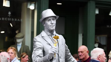 performer posing as a statue in a busy street