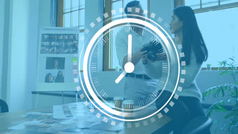 animation of clock ticking over diverse business people in office
