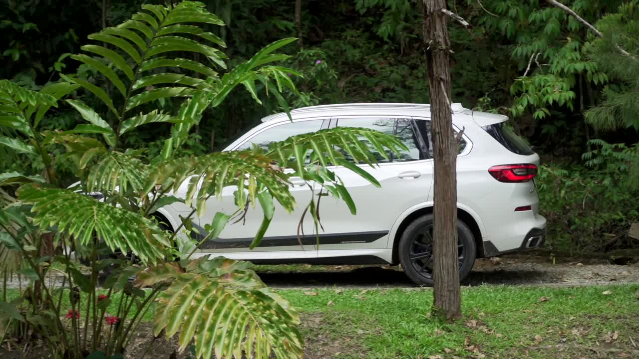 Kuala Lumpur, Malaysia - March 9, 2022: brand new car 2020 BMW X5 wheelhouse interior. Concept of luxury. Hybrid cars. white BMW X5 SUV driving down the street