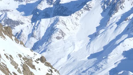 details on rocky and snowy mountain walls in the alps of tyrol - pan shot