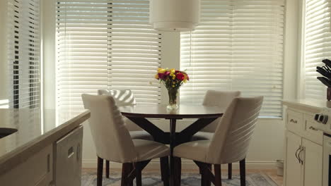 bright and airy kitchen with a slow-motion slide shot of a table with flowers