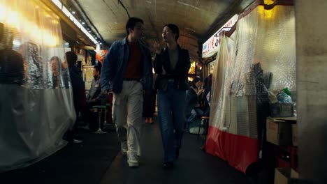couple exploring a night market in japan