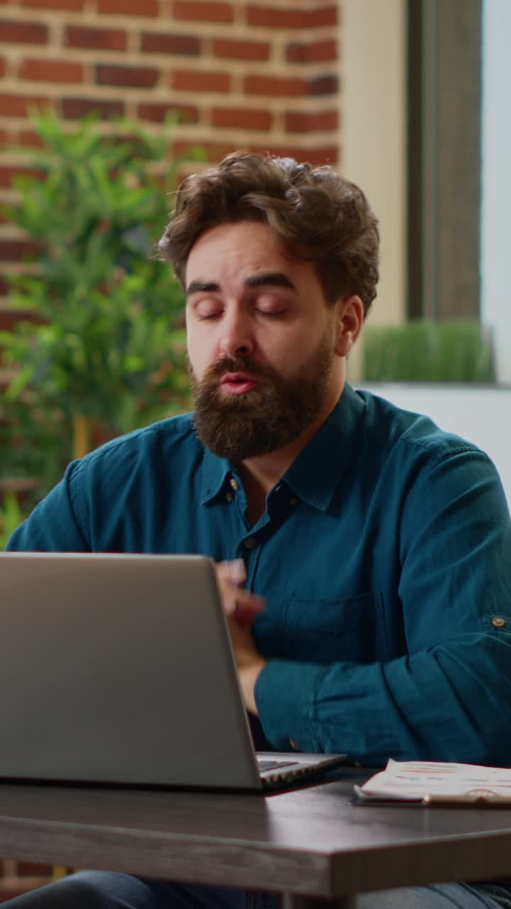 Worried man working on laptop in office