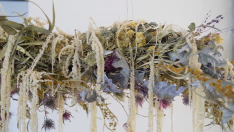 close up of hanging horizontal dry flower arrangement in a flower shop