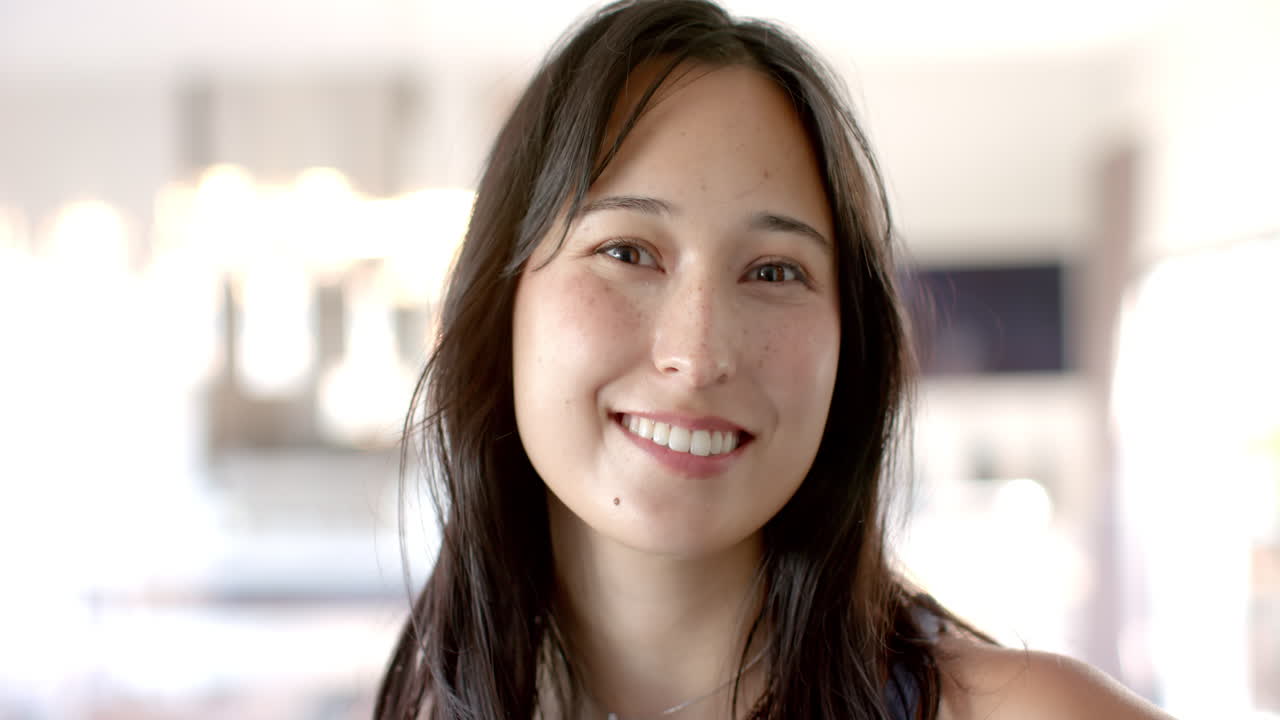 Smiling woman looking happy and relaxed indoors, enjoying her own company, copy space