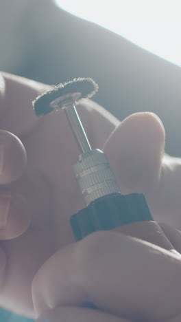 close up of a person working with small hand tools